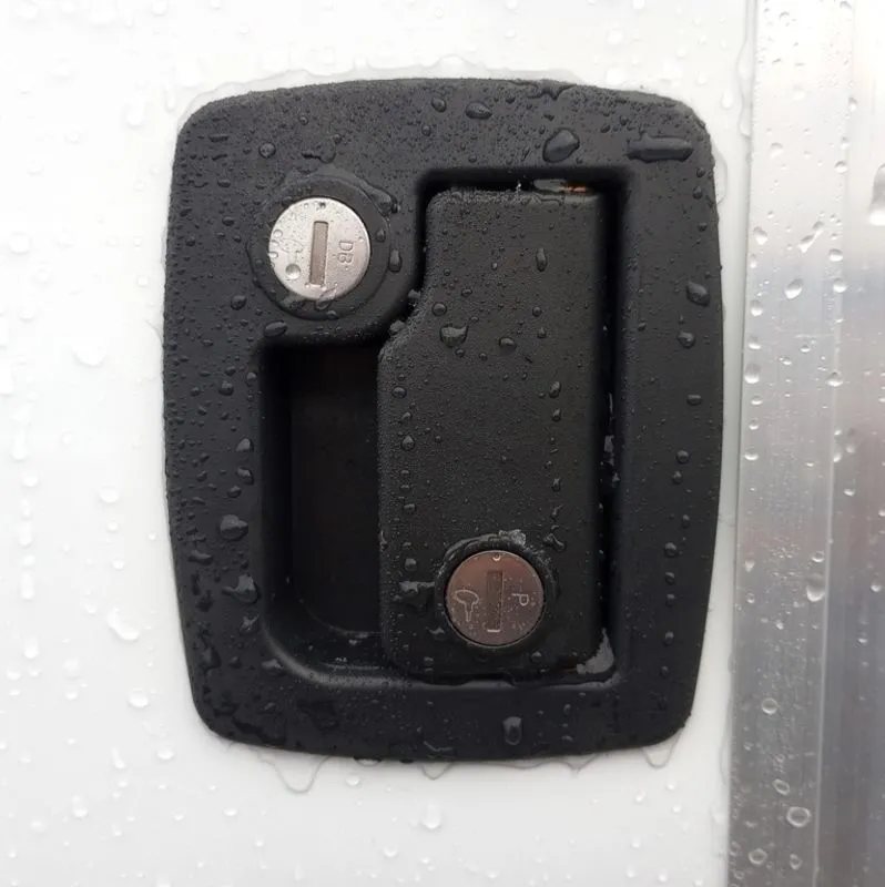 2024 Mission Trailers 12 ft Powersports – Side X Side – Close up of the black recessed locking door handle on the white exterior