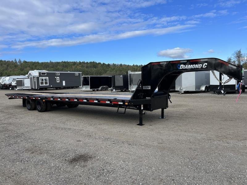 2024 Diamond C 35 ft Equipment Trailer – Auto Dovetail – The front gooseneck portion and deck of the trailer in a lot