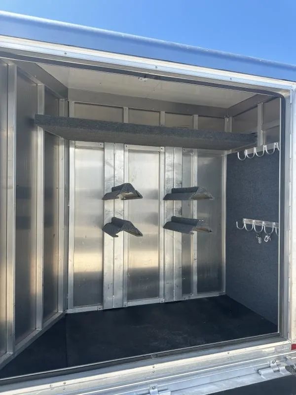 2020 Bloomer 4 Horse Stock Combo – Trainer Tack – Interior shot of the tack room with multiple saddle racks and hooks