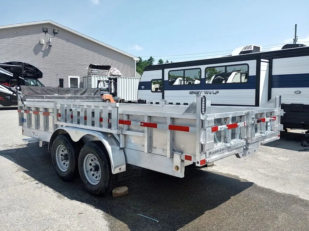 2025 Mission Trailers 16 ft Dump Trailer – Aluminum – Three-quarter rear view showing the tandem axles and side rail construction