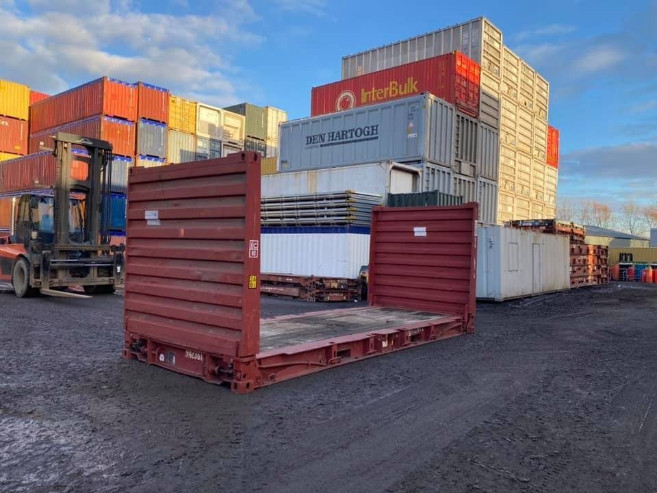 20ft Flat Rack Container – Folding Ends and Timber Deck – red flat rack container with upright ends in storage yard