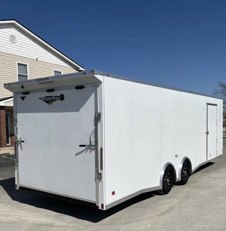 2025 Millennium Blaze 26 ft Car Hauler – Cabinets – Rear three-quarter view showing the closed ramp door and side profile of trailer