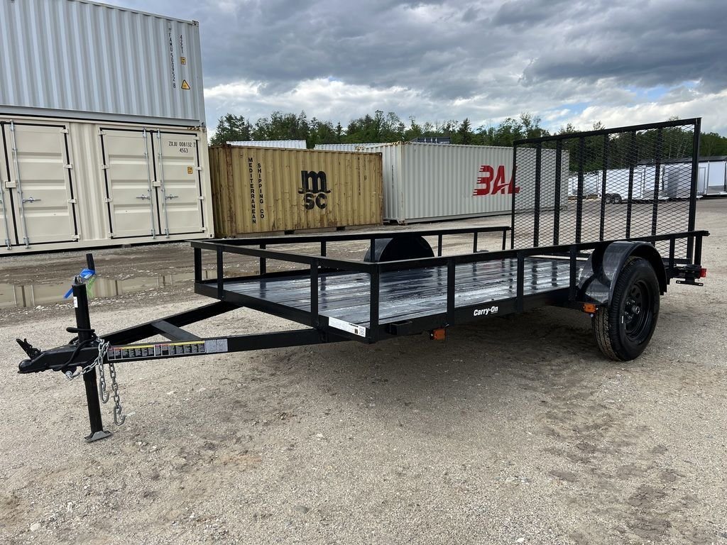 2024 Carry-On 12 ft Utility Trailer – Rear Ramp Gate – Front three-quarter view of a black utility trailer with mesh gate and wood deck
