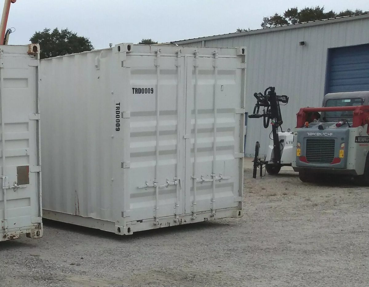 40ft High Cube Container Office – Storage Racking, Side Access – white container with closed cargo doors in equipment yard