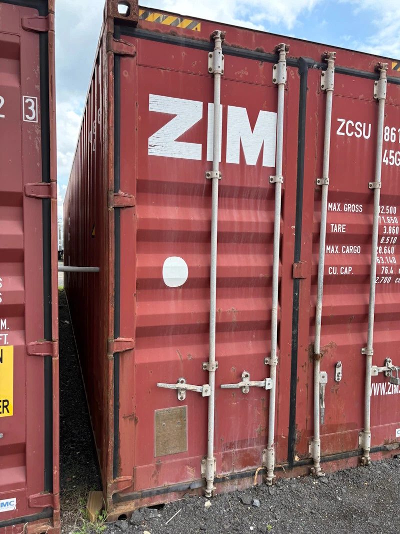 45ft Used High Cube Shipping Container – Red Storage Unit – weathered red container cargo doors beside another container