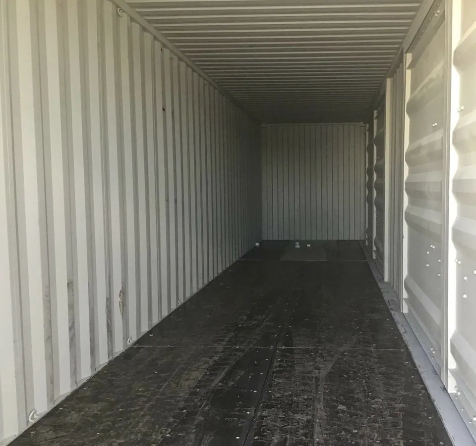 40ft High Cube Shipping Container – One-Trip, Two Side Doors – empty container interior with corrugated walls and dark plywood floor