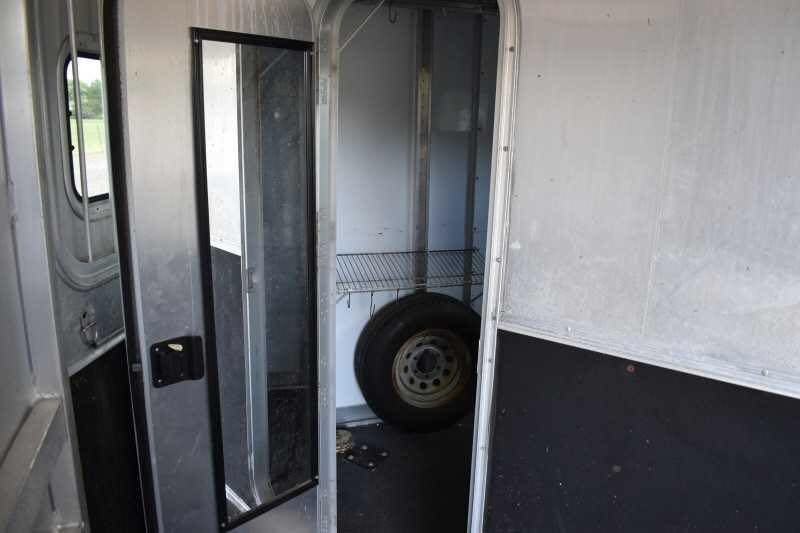 2002 Exiss SS20 2 Horse Trailer – Walk-Through Dressing Room – View of the tack room interior showing white walls and black flooring