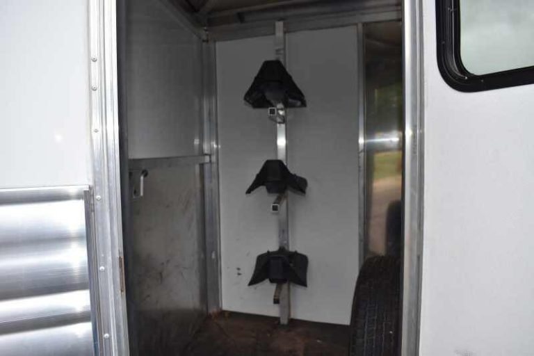 2012 CM 3 Horse Bumper Pull Trailer – Aluminum, Hayrack – Interior of the tack room showing a triple saddle rack mounted to wall