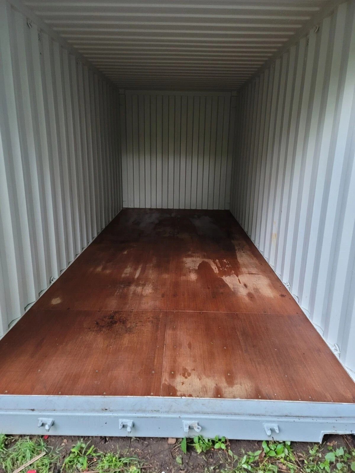 20ft Used Shipping Container – Wind & Watertight Storage – empty container interior with corrugated walls and stained wooden floor