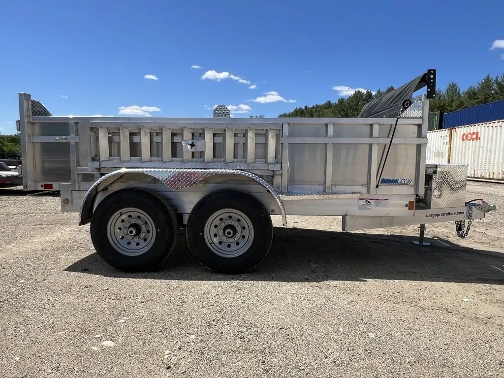 2024 Cargo Pro 12 ft Dump Trailer – Aluminum – Full side profile view of the aluminum dump trailer on gravel