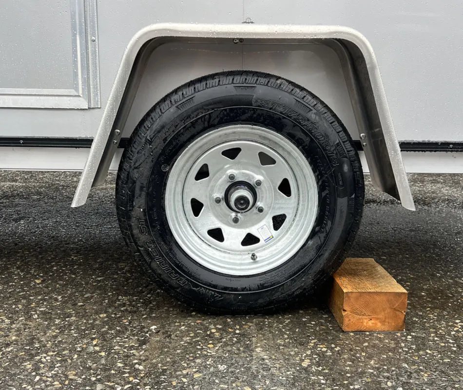 2024 Mission Trailers Crossover Trailer – Galvanized Package – Close-up of the trailer wheel with white rim and galvanized fender