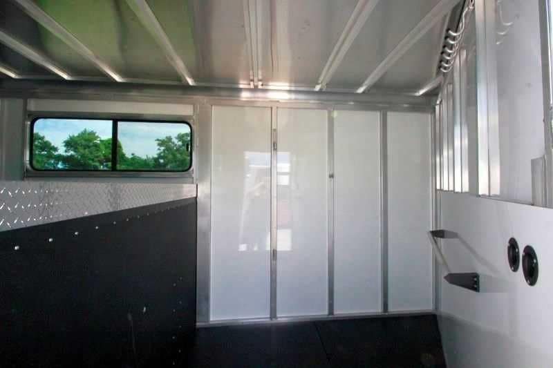2016 Sundowner 3 Horse Gooseneck – Aluminum, Dressing Room – Tack room interior featuring white walls, a window, and black rubber floor matting