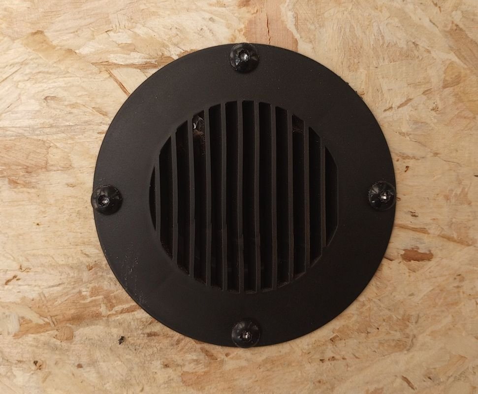 Mission Trailers 22 ft Snowmobile Trailer – 4-Place – Close-up of a circular black plastic vent mounted on the interior wood wall