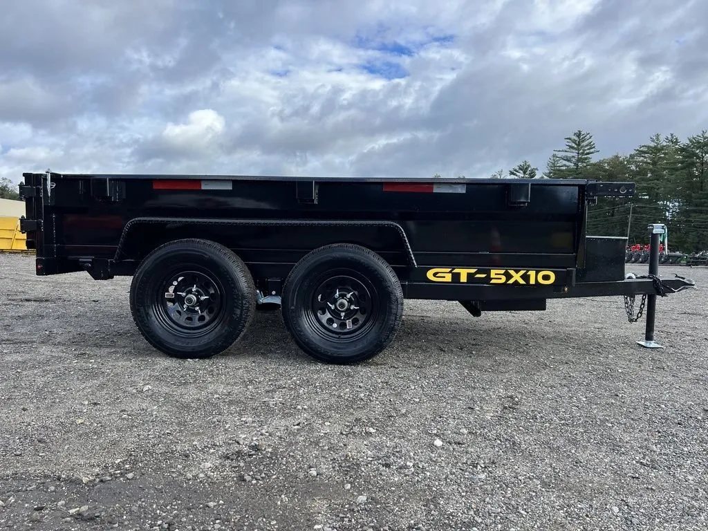 2024 Griffin Trailers 10 ft Dump – Barn Door Gate – Full left side profile of the black dump trailer against a cloudy sky