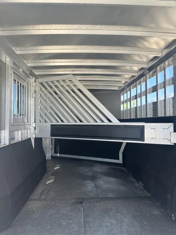 2020 Bloomer 4 Horse Stock Combo – Trainer Tack – Interior horse stall area with metal dividers and rubber floor mats
