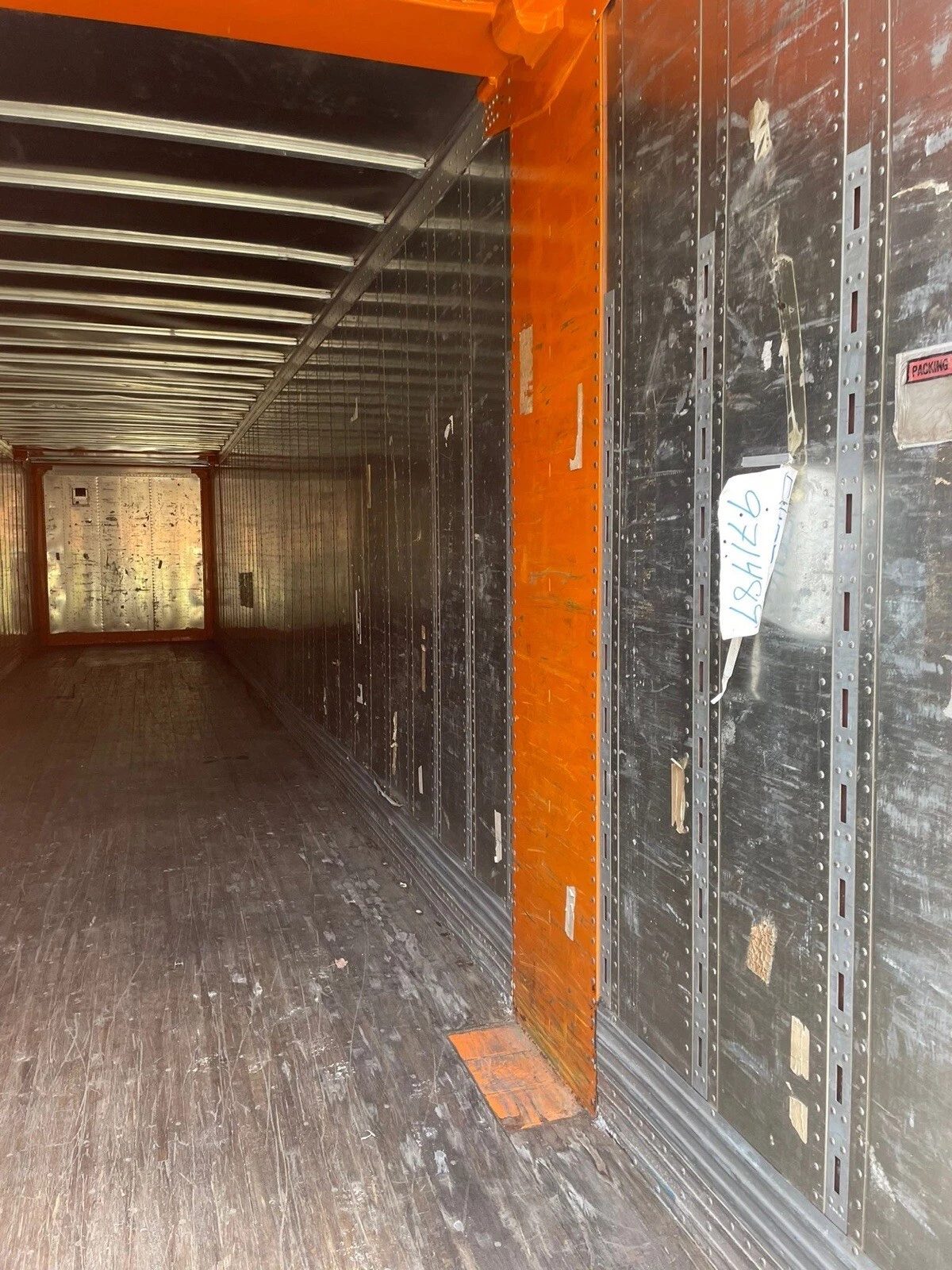 53ft High Cube Shipping Container – Aluminum Construction – empty container interior with metal walls and worn wooden floor