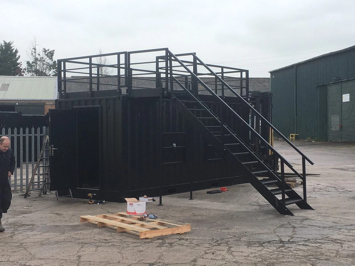 20ft Converted Shipping Container – Serving Hatches and Roof Deck – black converted container with rooftop terrace and external staircase