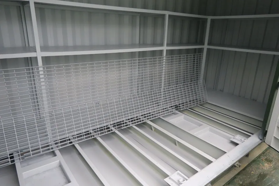 20ft Bunded Storage Container – Integrated Spill Containment – Storage container interior with shelving and exposed bunded floor