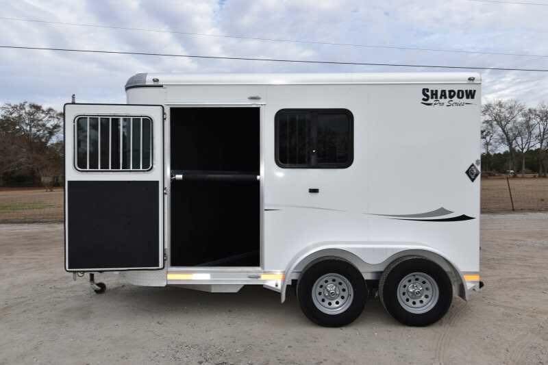 2016 Shadow 2HBP 2 Horse Bumper Pull Trailer – Aluminum – Left side view of white horse trailer with open entry door