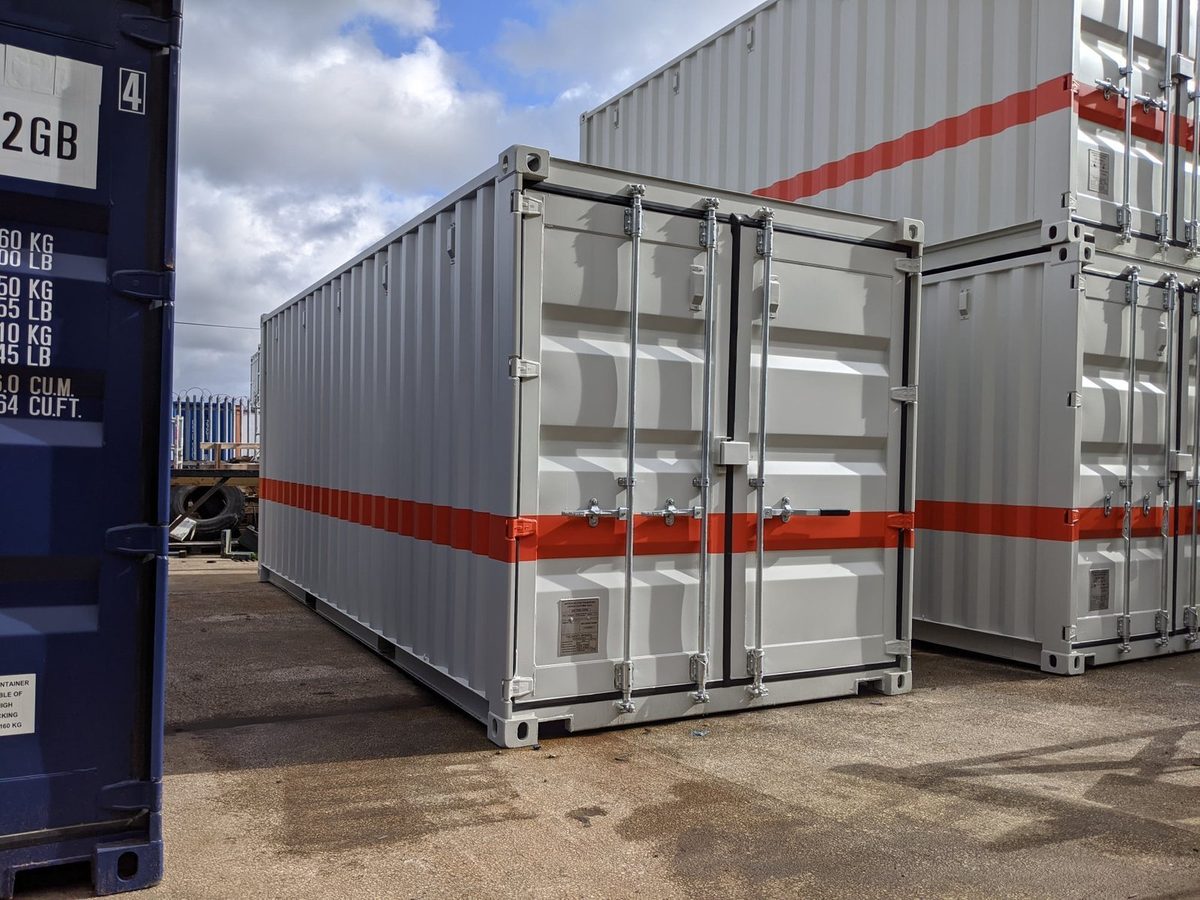 20ft Custom Workshop Container – Built-In Steel Shelving – three-quarter exterior view with closed cargo doors and orange stripe