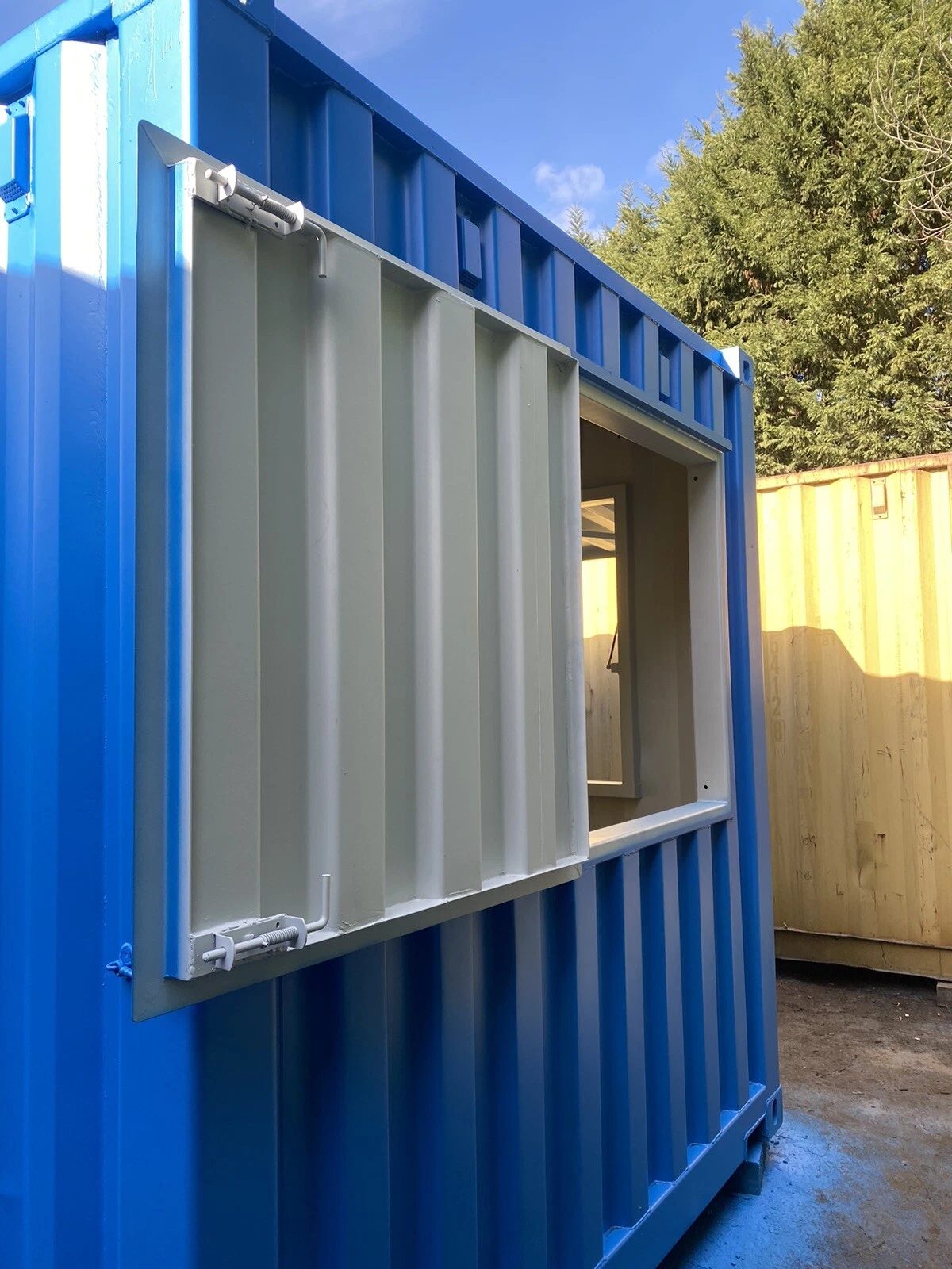15ft Custom Container Bar & Kiosk – Side Service Hatches – blue container service window with partially open metal shutter