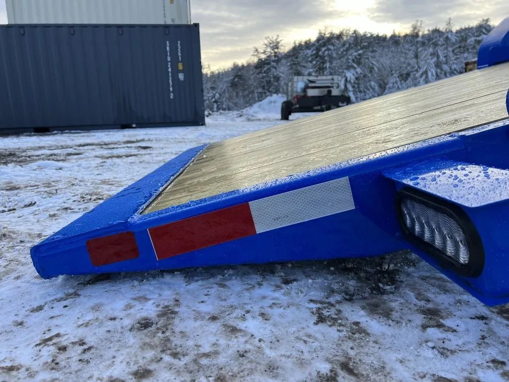 2024 Rice Trailers 20 ft Tilt Trailer – Spare Mount – Close-up view of the rear tail light and the edge of the blue frame