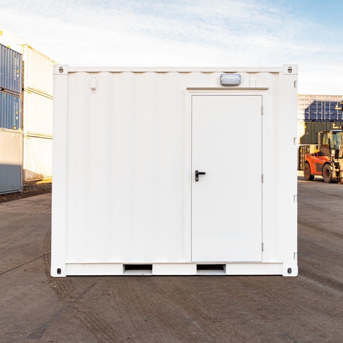 10ft Custom Workshop Shipping Container – Unfitted Steel Shell – white modified container with closed personnel door and exterior light