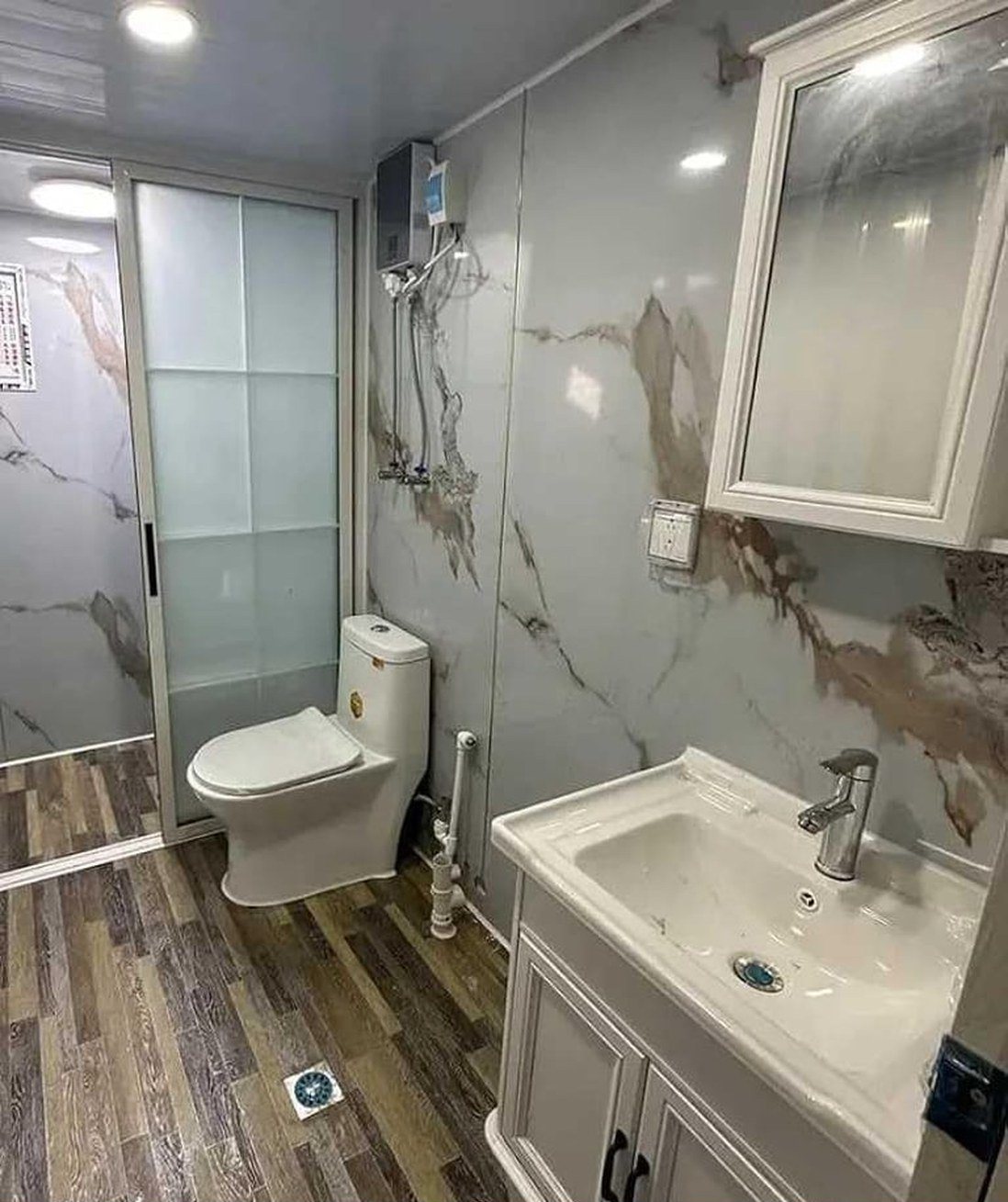 40ft Foldable Home – 3 Bedrooms, Glazed Front – Full bathroom with marble-look panels, sliding shower screen and vanity