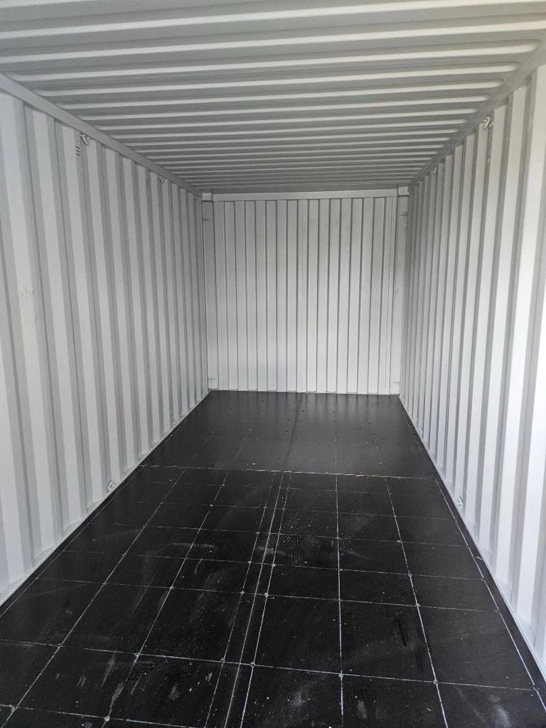 20ft Wind & Watertight Storage Container – Camouflage Finish – empty container interior with light corrugated walls and dark floor