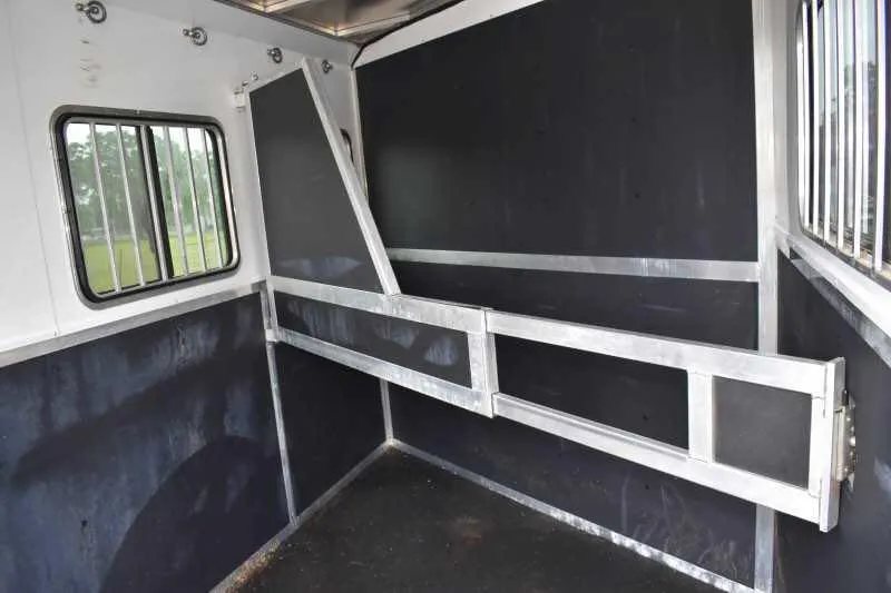 2013 Shadow 2HSL 2 Horse Trailer – Aluminum, Dressing Room – Interior horse stall area with black padded walls and aluminum divider gate