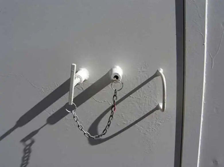 Explosive Storage Magazine – White, Insulated – Close up view of the secure door locking mechanism with chain and pins