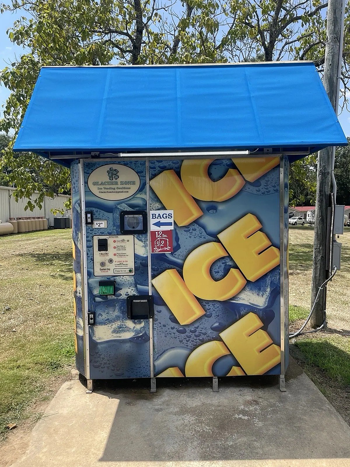 Commercial Ice Vending Machine – Bagged and Bulk Dispensing – front view of outdoor ice vending machine with blue canopy