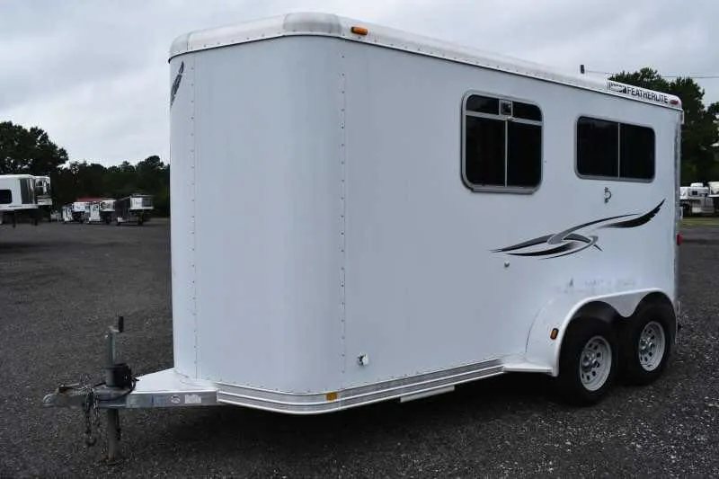 2003 Featherlite 2HST 2 Horse Trailer – Aluminum – Front three-quarter view from the driver side showing the smooth white nose