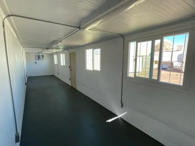 40ft Converted Office Container – Insulated, Four Barred Windows – empty container office with windows and dark flooring