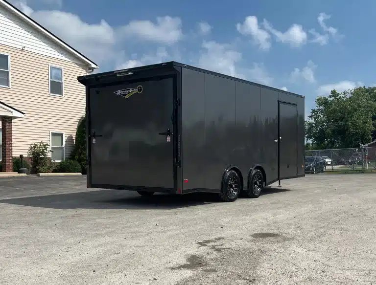 2025 Millennium 20 ft Car Hauler – Black-Out Package – Rear three-quarter view showing the ramp door and side profile of the trailer
