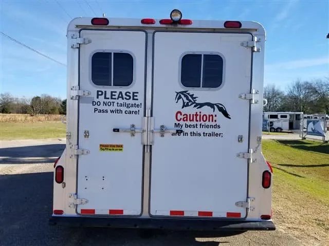 2001 4 Star 2 Horse Bumper Pull Trailer – Slant Load – Straight on rear view of the closed white double trailer doors
