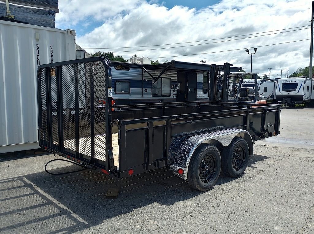 2024 PJ Trailers 14 ft Utility – Solid Metal Sides – Rear three-quarter view with the mesh ramp gate in the upright position