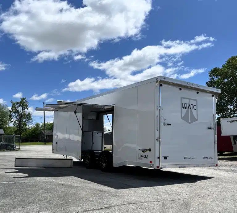 2025 ATC 24 ft Car Hauler – Large Escape Door – Three-quarter rear exterior view of a white car trailer with open escape door