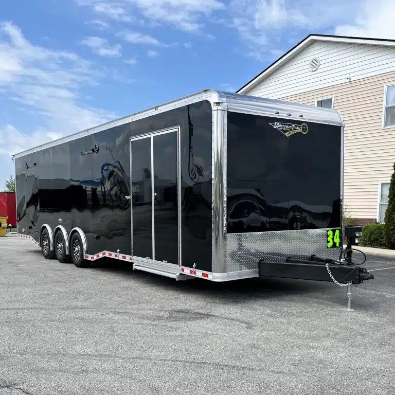 2025 Haulmark Edge 34 ft Race Trailer – Turbo Package – A three-quarter exterior view of a black enclosed car trailer showing the side and front