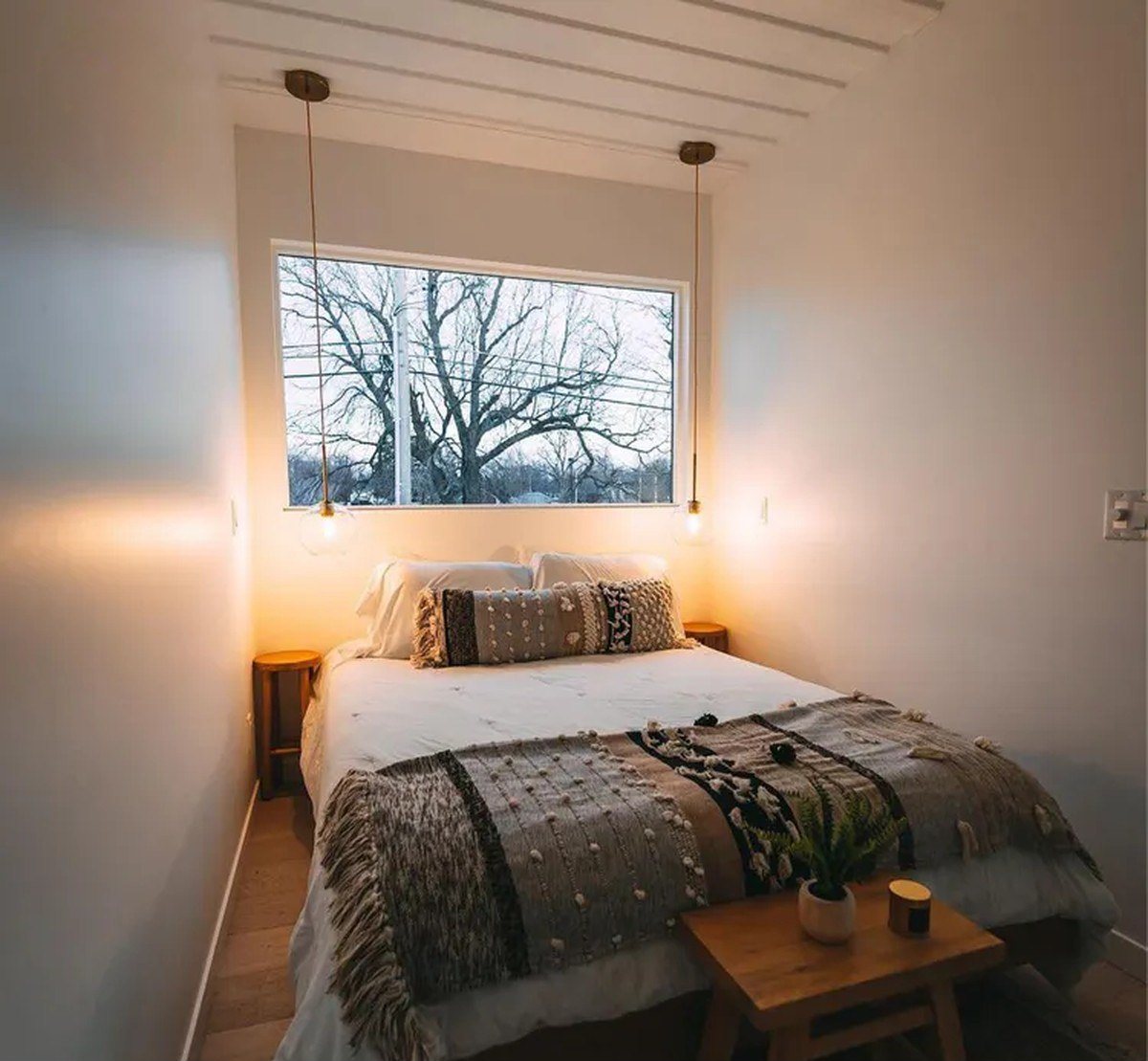 3-Bedroom Duplex Container Home – Rooftop Deck – Bright ground-floor bedroom framed by a full-width picture window