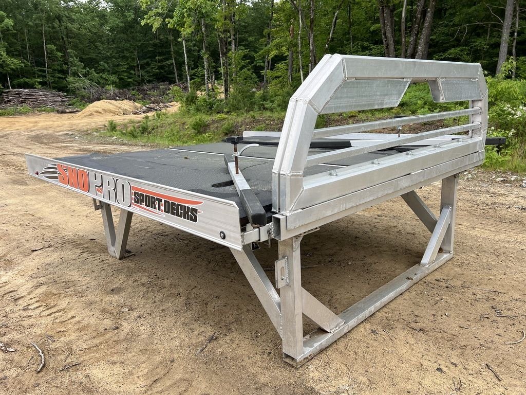 2022 Sno Pro 7 ft Sled Deck – Quad Ply Decking – Front three quarter view of an aluminum sled deck on a stand outdoors