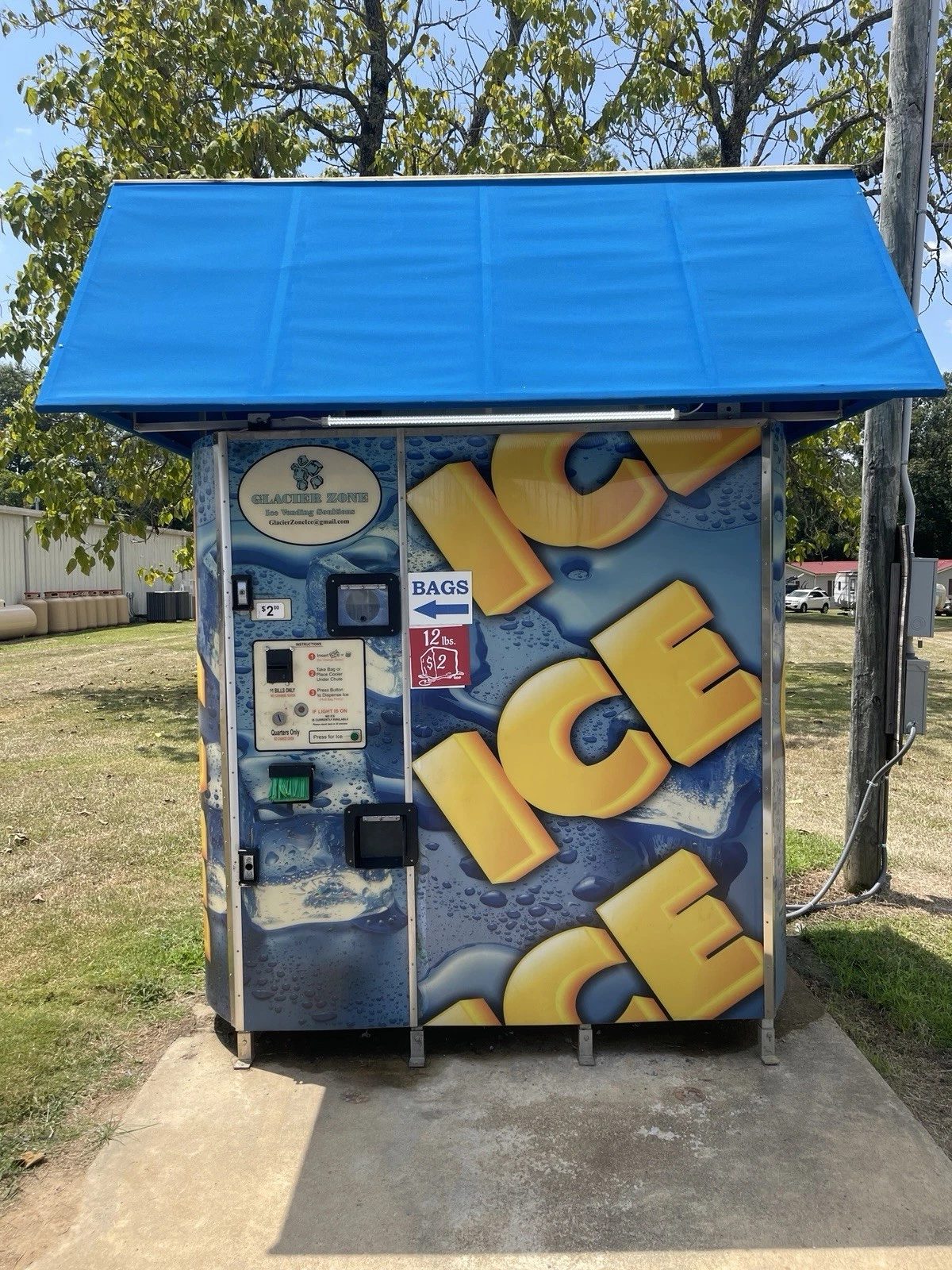 Commercial Ice Vending Machine – Bagged and Bulk Dispensing – front view of outdoor ice vending machine with blue canopy