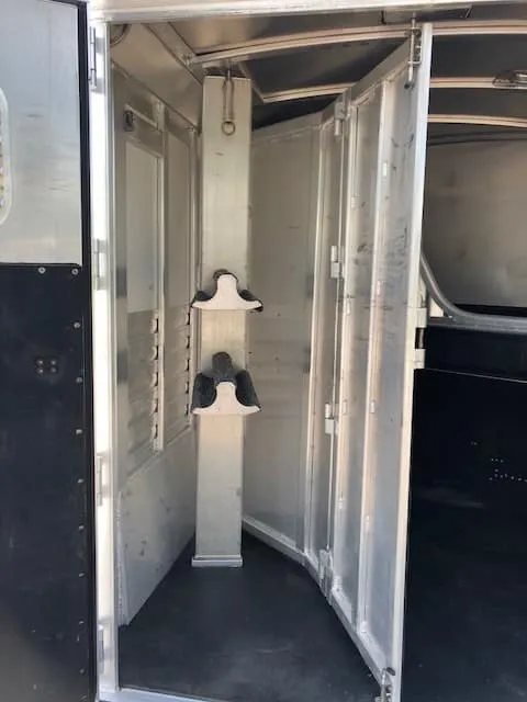 2004 4 Star 2 Horse Gooseneck Trailer – Slant Load, White – Rear tack area with a swing-out saddle rack and storage space