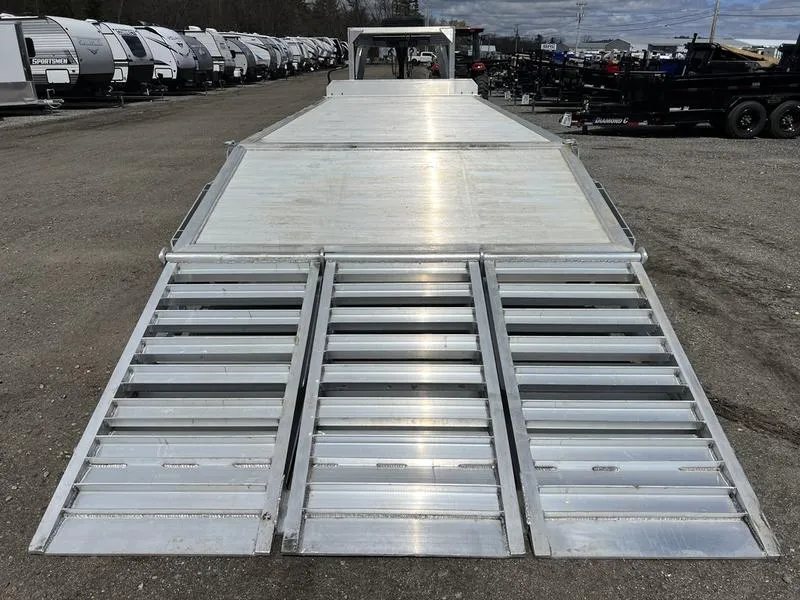 2024 Alum-Line 24 ft Gooseneck – Flip-Over Ramps – Rear view looking up the length of the trailer deck with ramps down