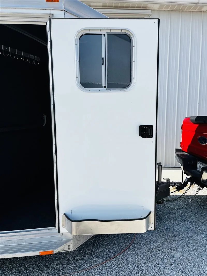 2015 4 Star 2 Horse Bumper Pull – Slant Load, Rear Tack – Open white entry door showing the interior carpeted wall and bridle hooks