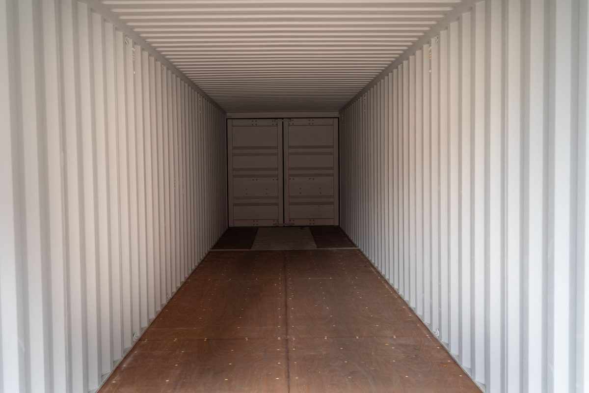 40ft New Shipping Container – Double-End Cargo Doors – empty container interior with wooden floor and closed far doors
