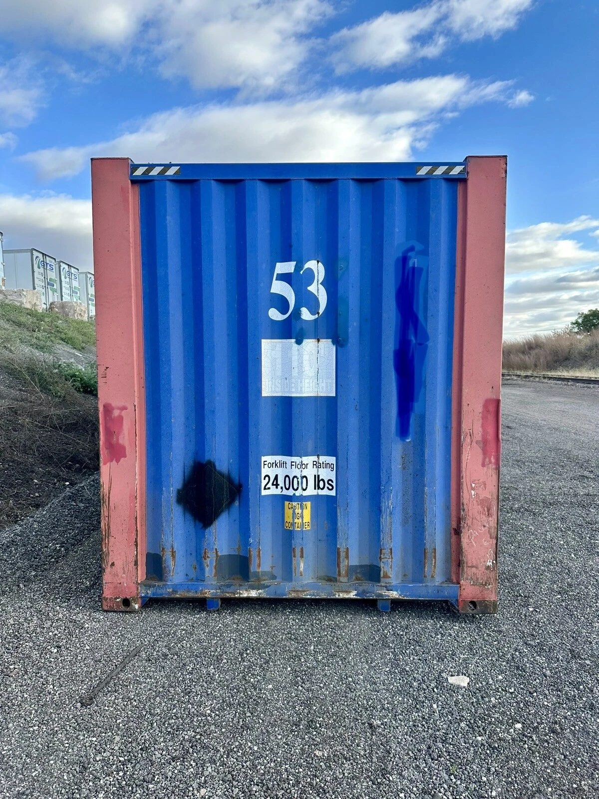 53ft High Cube Steel Shipping Container – Double End Doors – straight-on container end with rust and painted markings