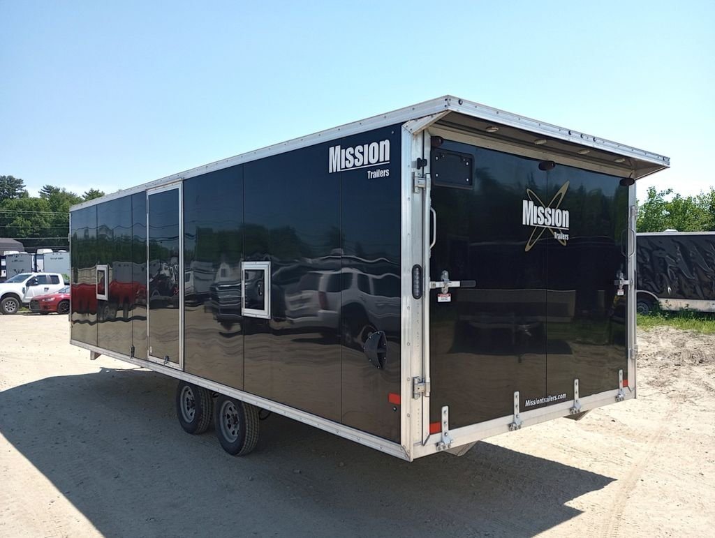 Mission Trailers 22 ft Snowmobile Trailer – 4-Place – Rear three-quarter view of the black trailer showing the closed ramp door and side