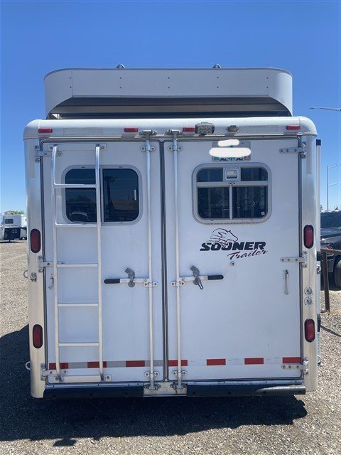 2000 Sooner 4 Horse Bumper Pull – Dressing Room, Awning – Direct rear view of the closed double doors and a ladder