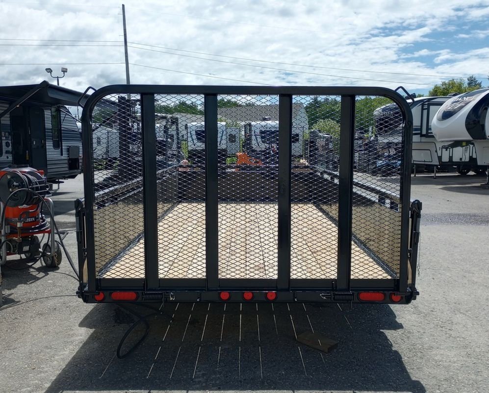 2024 PJ Trailers 14 ft Utility – Solid Metal Sides – Straight-on rear view of the trailer showing the mesh gate and tail lights